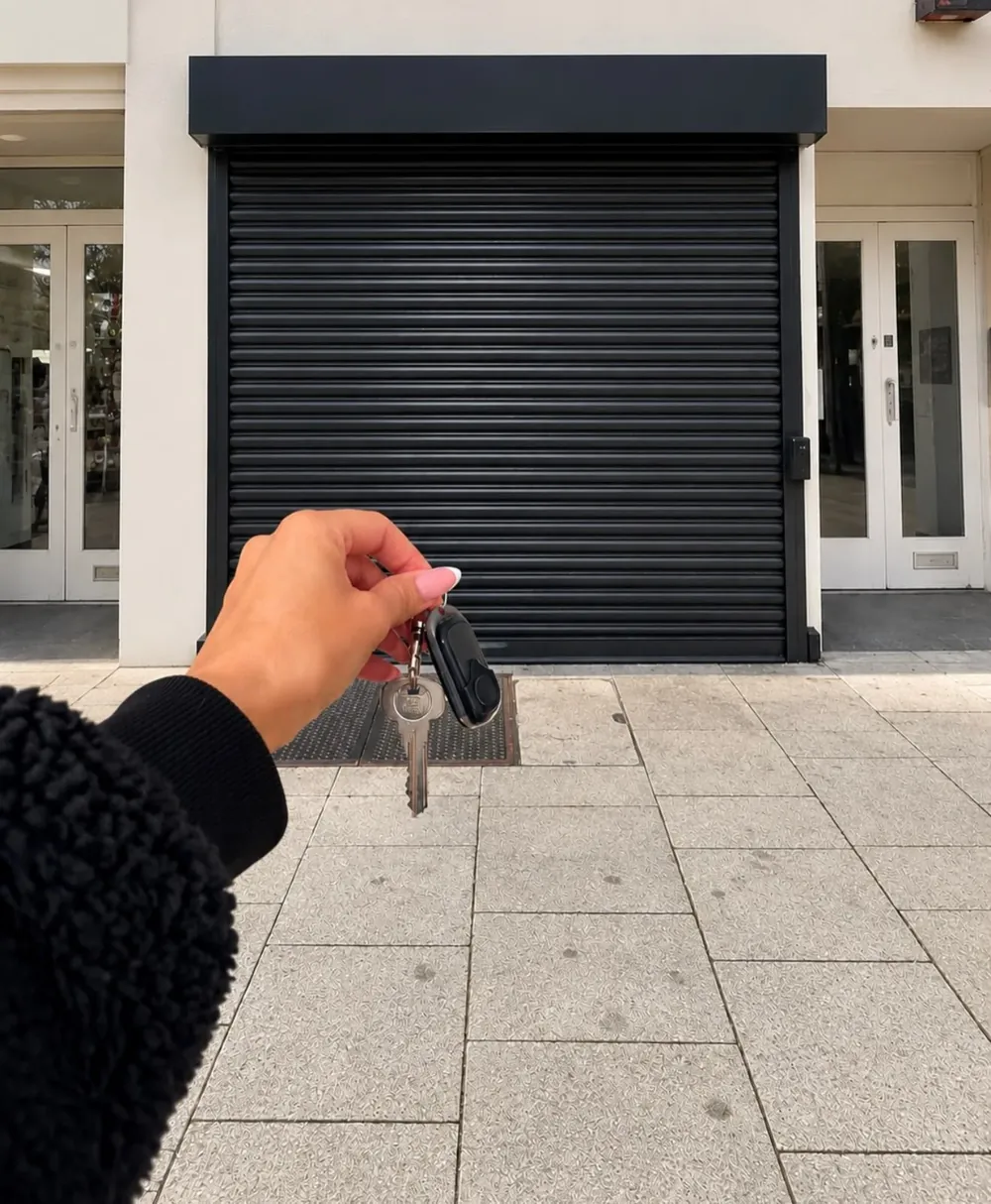 Rebecca holding up the keys to her new clinic